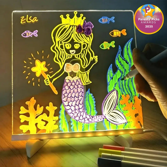 Kids drawing glowing artwork on LumiBoard Christmas-themed light-up drawing board.